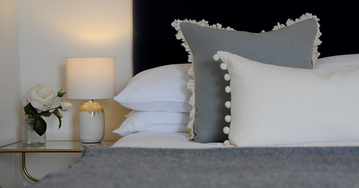 bolster cushions displayed with bed throws on matching bedding