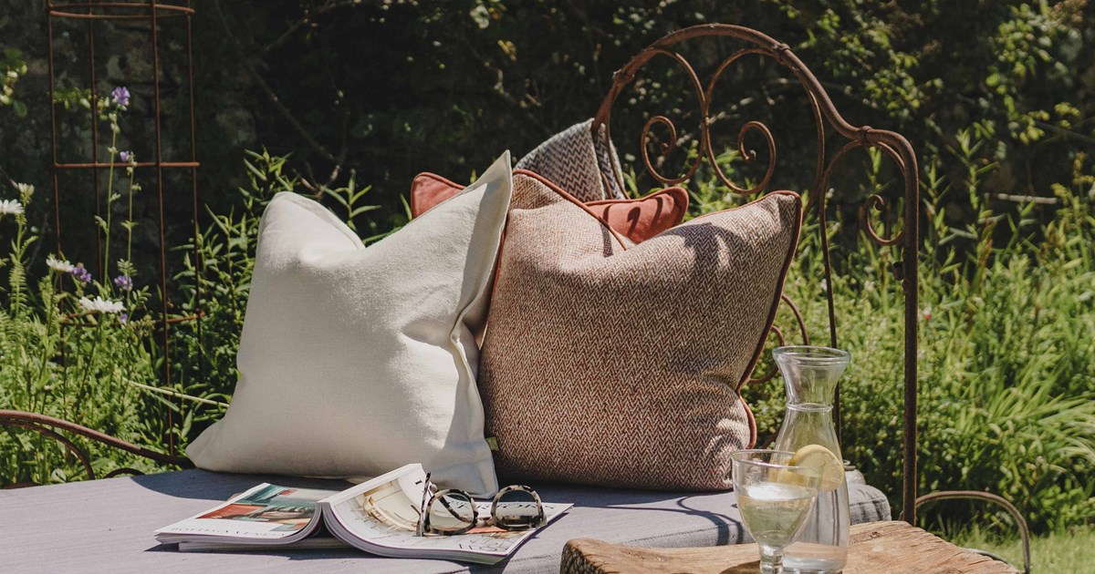 Luxury scatter cushions and sofa throw creating the perfect outdoor space for summer
