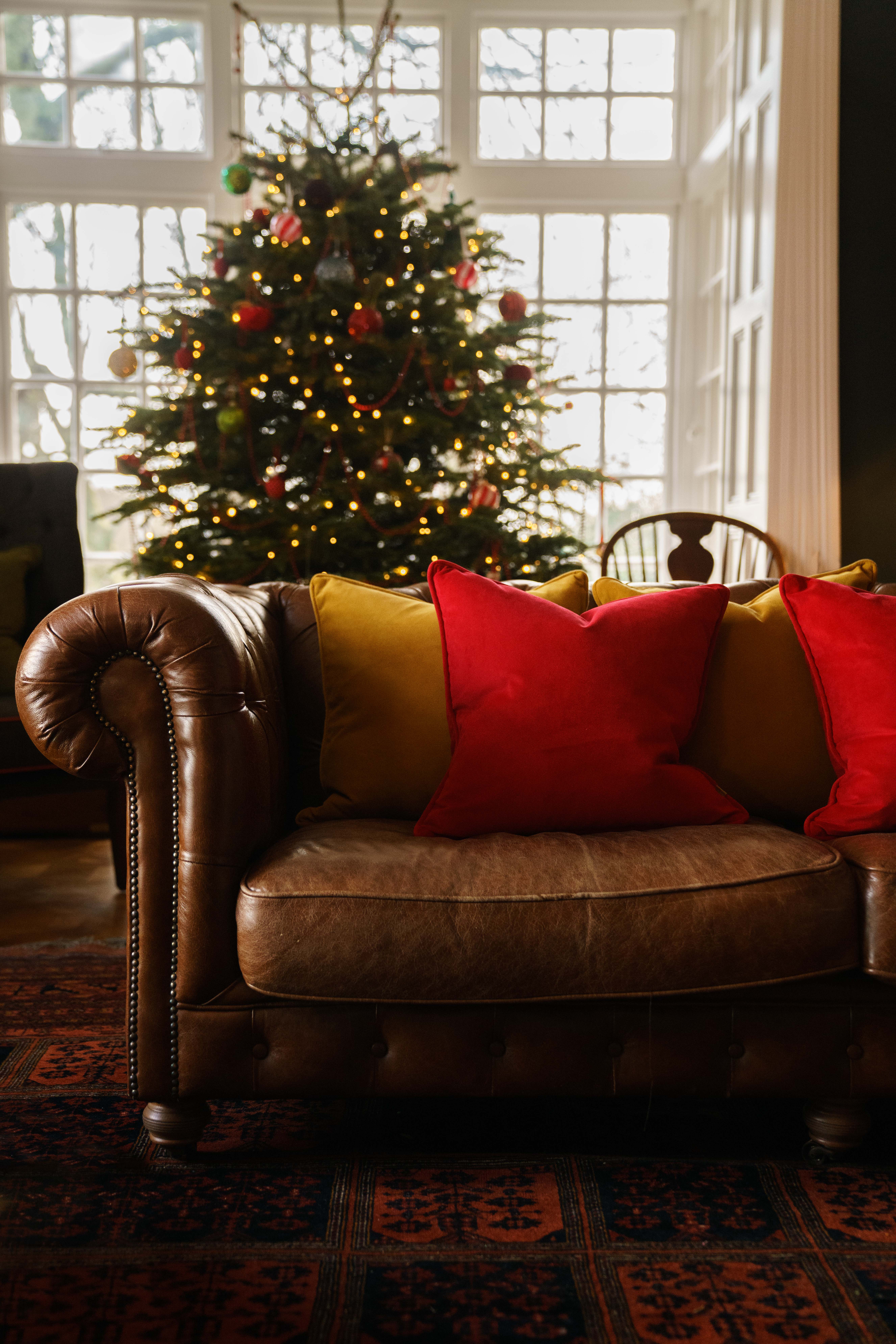 Handmade luxury cushions on the sofa by the Christmas tree.