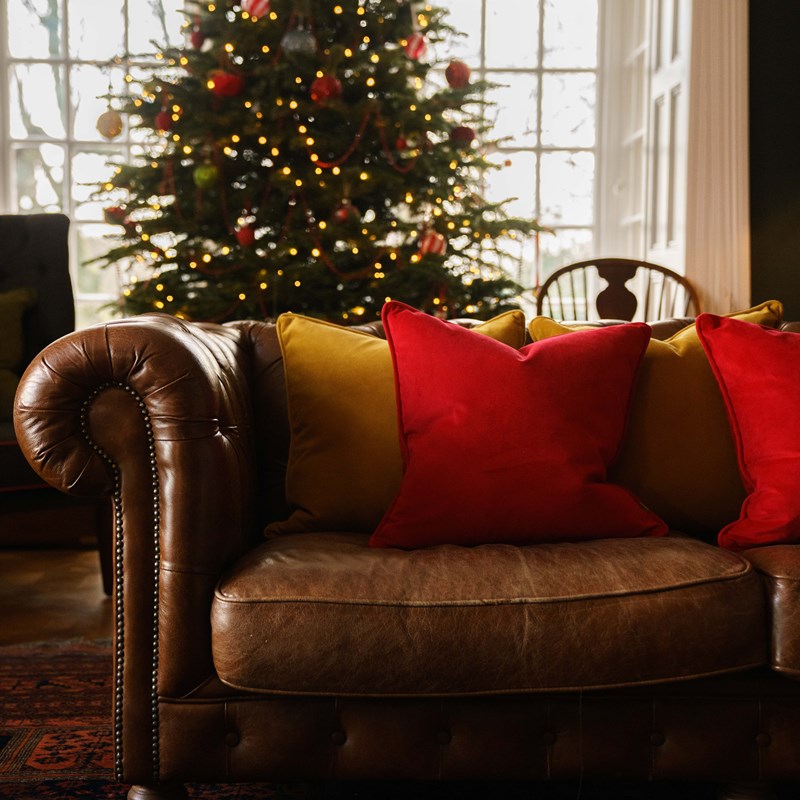 Handmade luxury cushions on the sofa by the Christmas tree.
