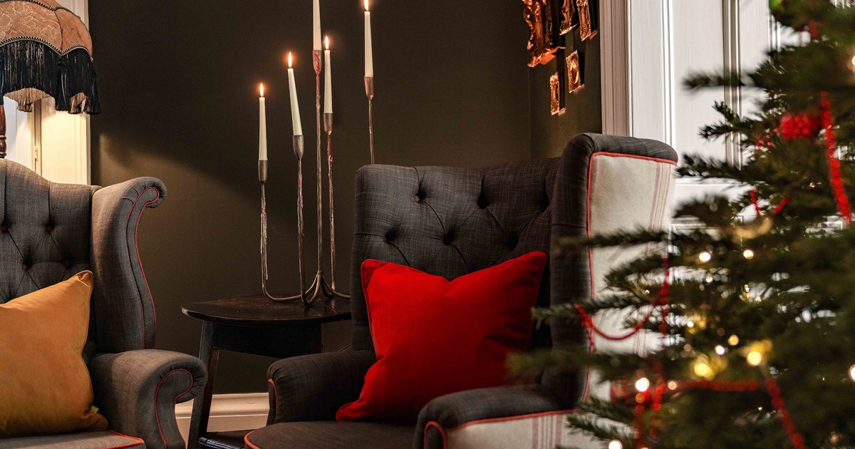 Luxury velvet cushion displayed in a festive setting.