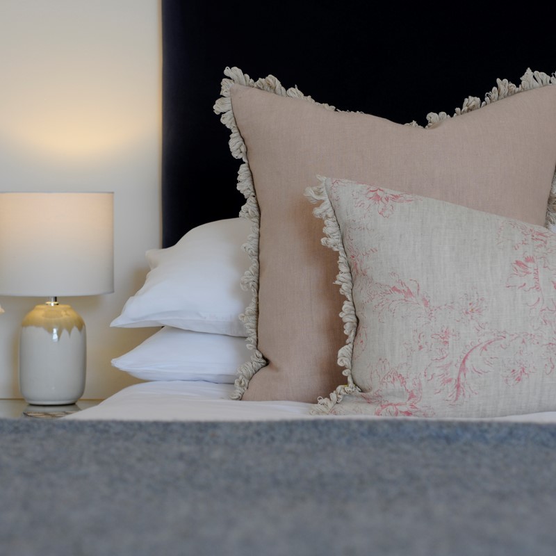 Luxury pillow bolsters by Boeboes, styled in an interior space.